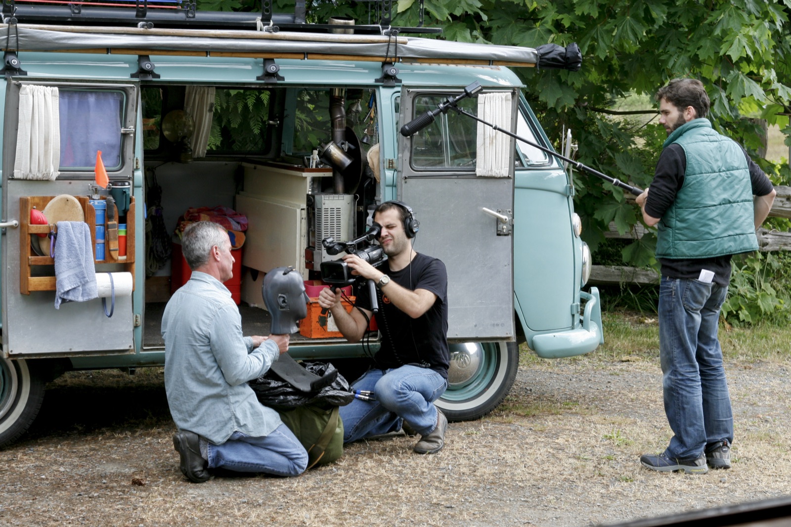 The crew sets up beside Gordon's Volkswagen van in the woods.